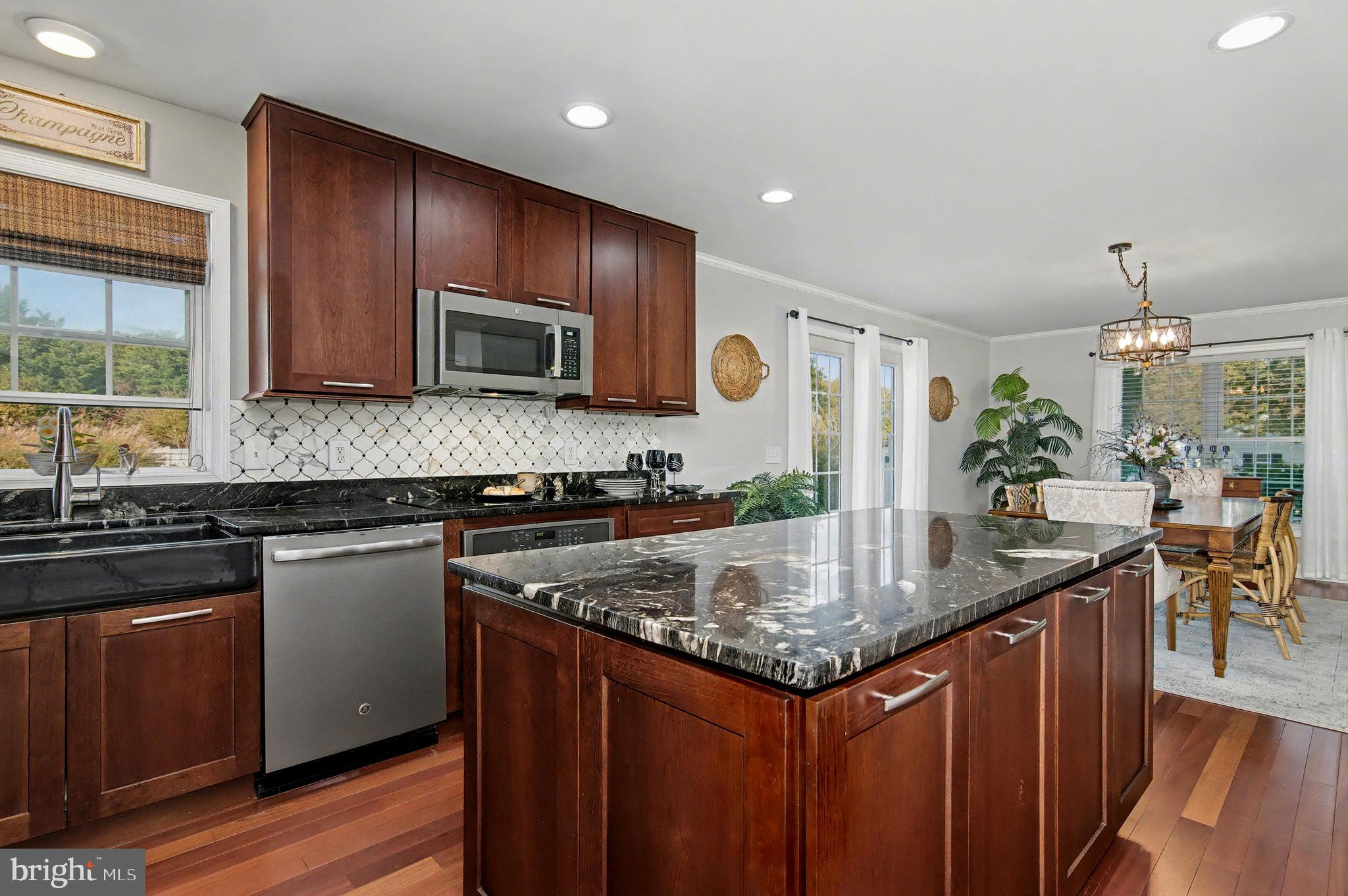 6660 Reeses Pride Road Sherwood, MD 21665 - Photo 38 of 72 a kitchen with stainless steel appliances granite countertop a sink stove and microwave