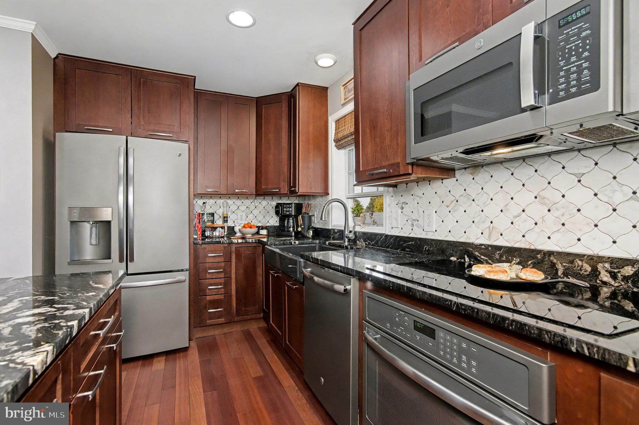 6660 Reeses Pride Road Sherwood, MD 21665 - Photo 39 of 72 a kitchen with stainless steel appliances a stove a sink and a refrigerator