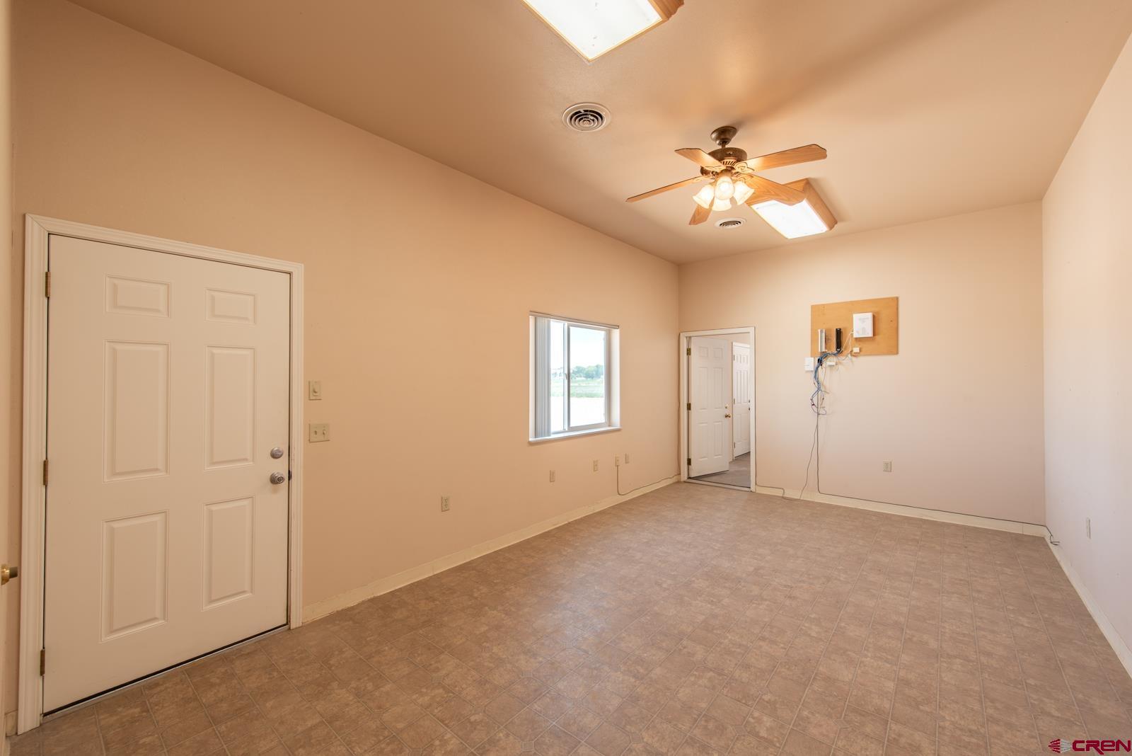 11604 5800th Road Montrose, CO 81403 - Photo 20 of 43 an empty room with windows and fan