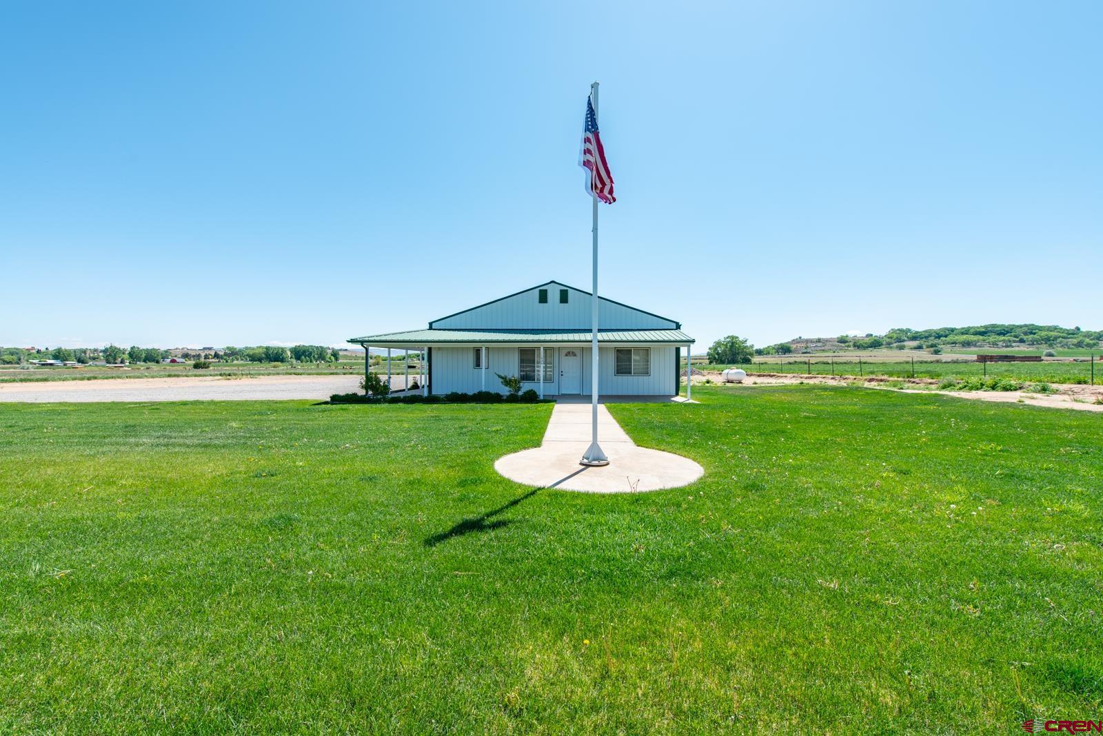 11604 5800th Road Montrose, CO 81403 - Photo 2 of 43 a view of a garden with a table and chairs