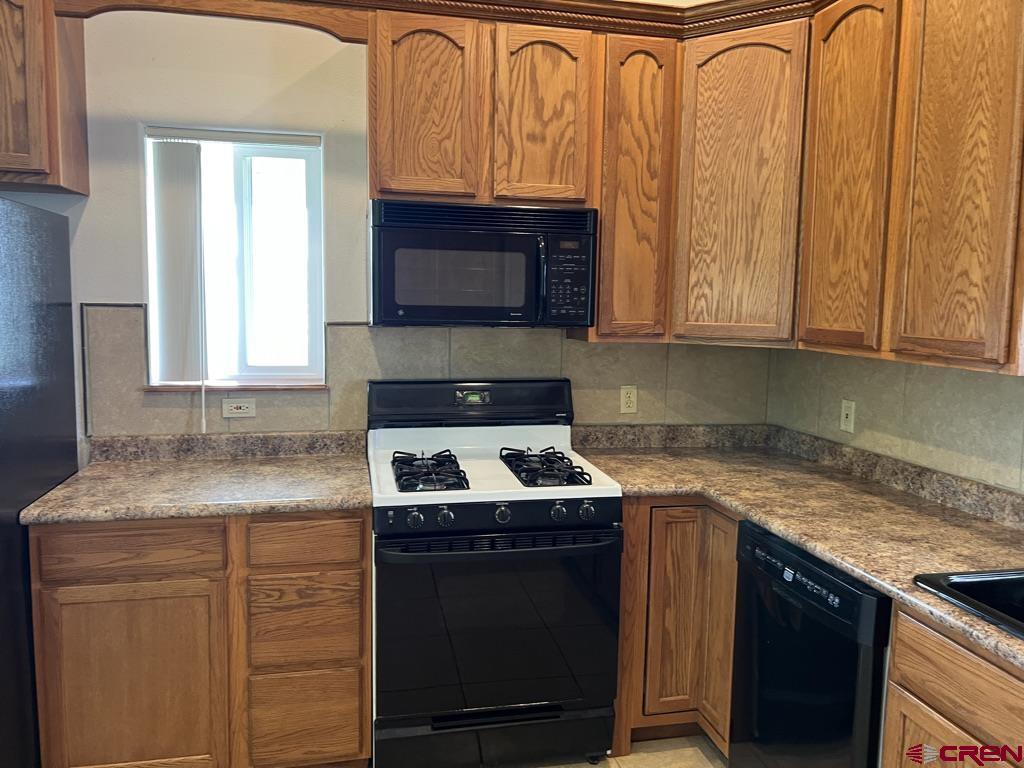 11604 5800th Road Montrose, CO 81403 - Photo 4 of 43 a kitchen with granite countertop cabinets stainless steel appliances and a sink