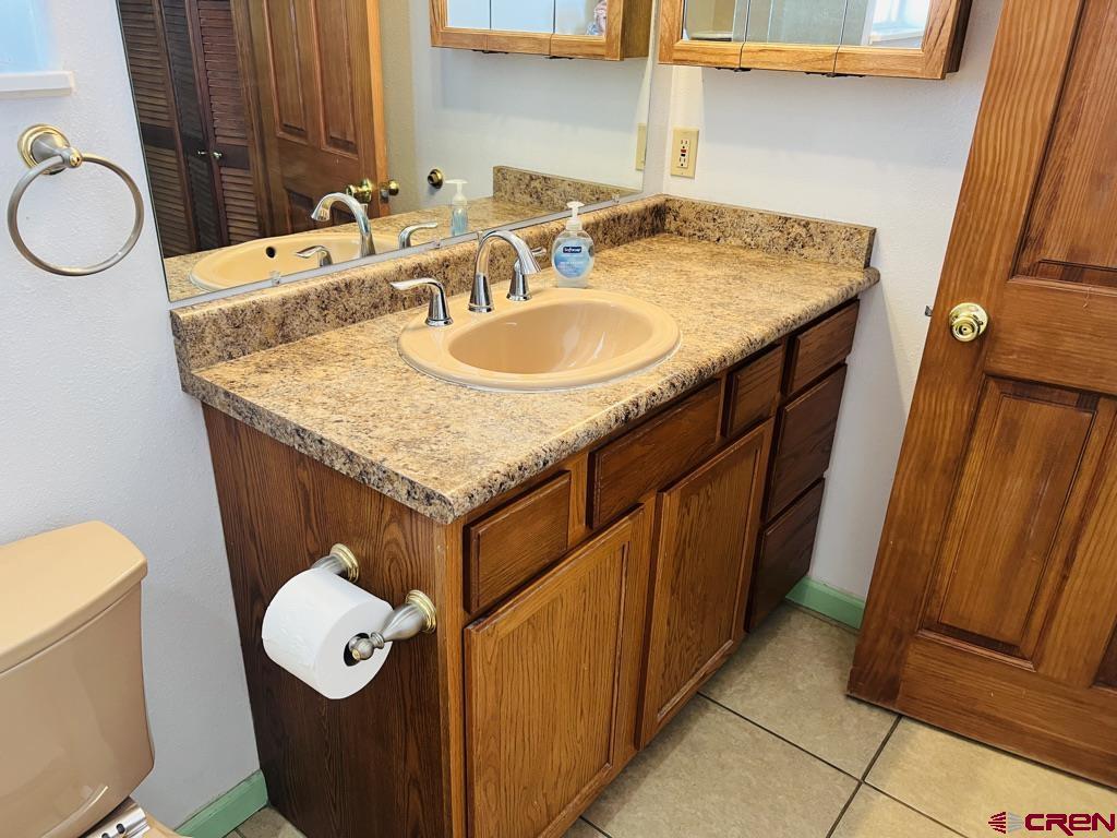 11604 5800th Road Montrose, CO 81403 - Photo 6 of 43 a bathroom with a granite countertop sink and a mirror