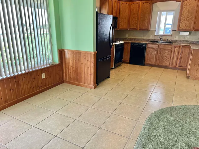 a kitchen with stainless steel appliances granite countertop a refrigerator and a stove