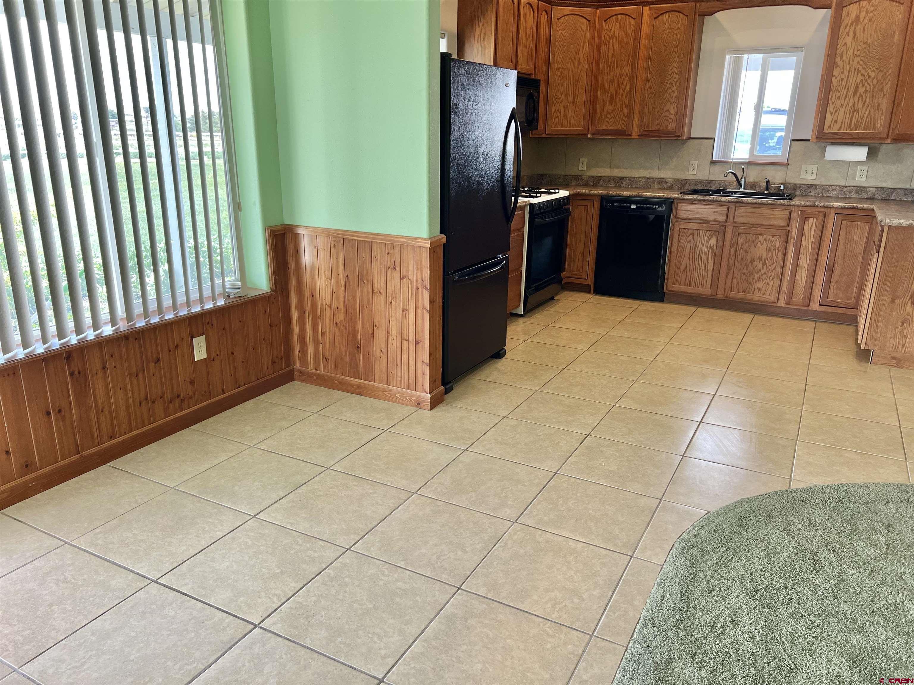 11604 5800th Road Montrose, CO 81403 - Photo 7 of 43 a kitchen with stainless steel appliances granite countertop a refrigerator and a stove