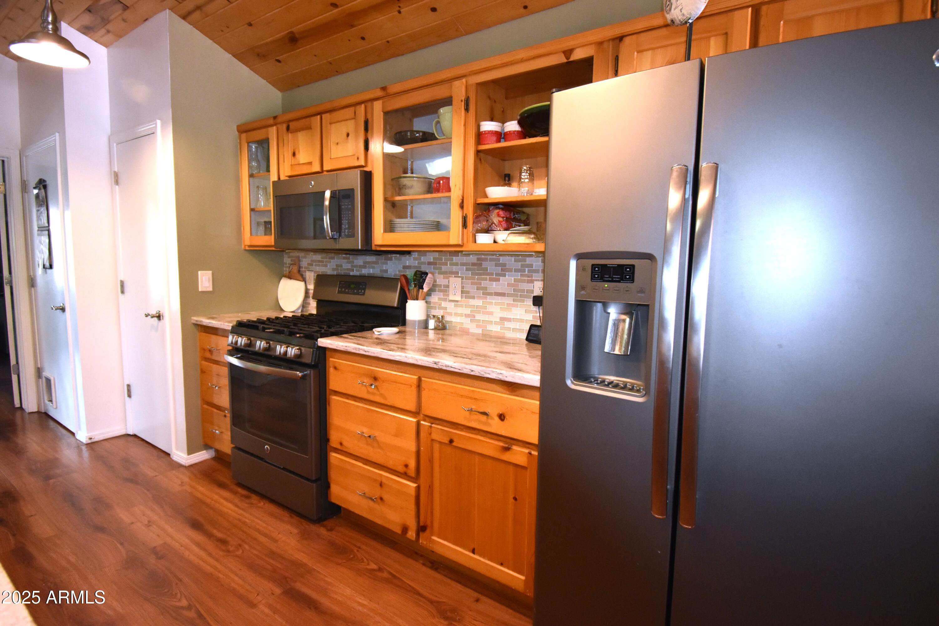 8742 Tonto Rim Drive Pine, AZ 85544 - Photo 13 of 41 a kitchen with stainless steel appliances granite countertop a refrigerator and a stove