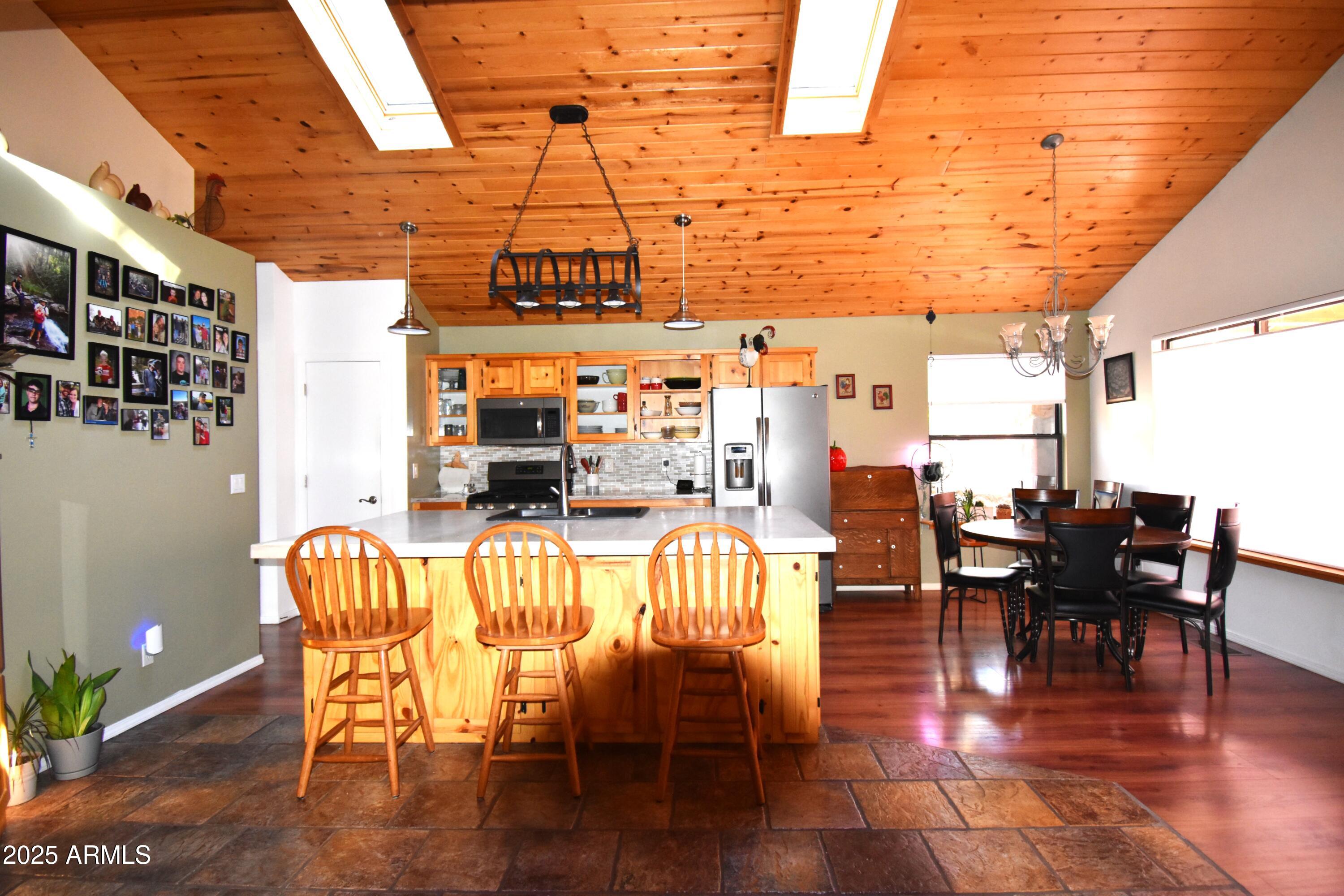 8742 Tonto Rim Drive Pine, AZ 85544 - Photo 16 of 41 a dining room with furniture a chandelier and wooden floor