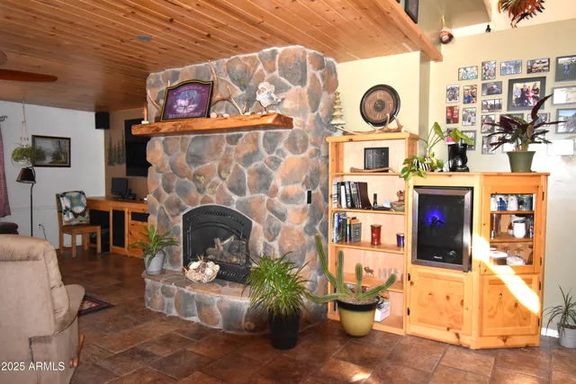 a living room with fireplace furniture and a wooden floor