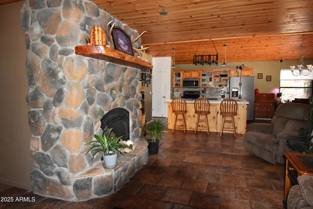 a living room with couches and a dining table with outer view