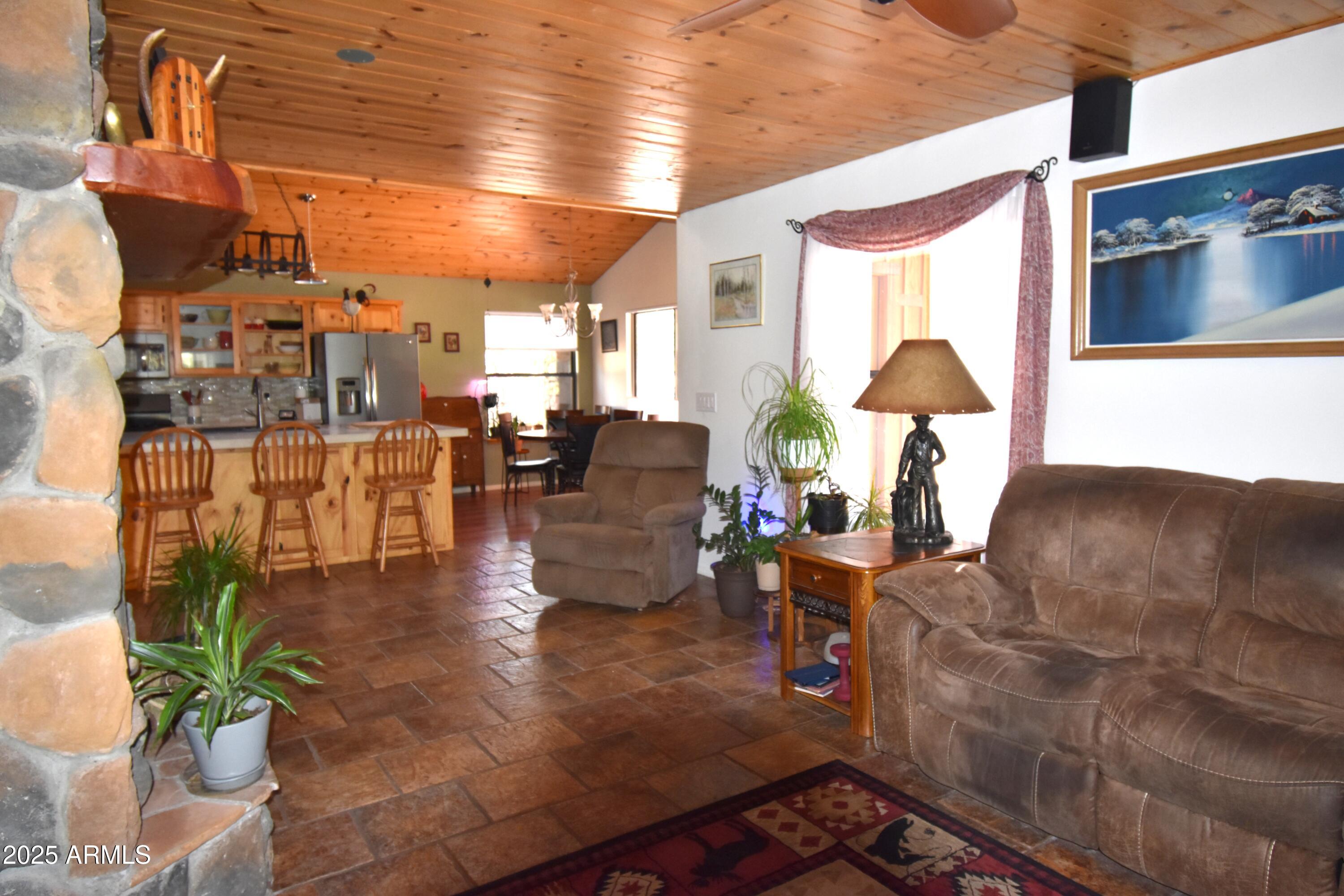8742 Tonto Rim Drive Pine, AZ 85544 - Photo 21 of 41 a living room with couches and a dining table with outer view
