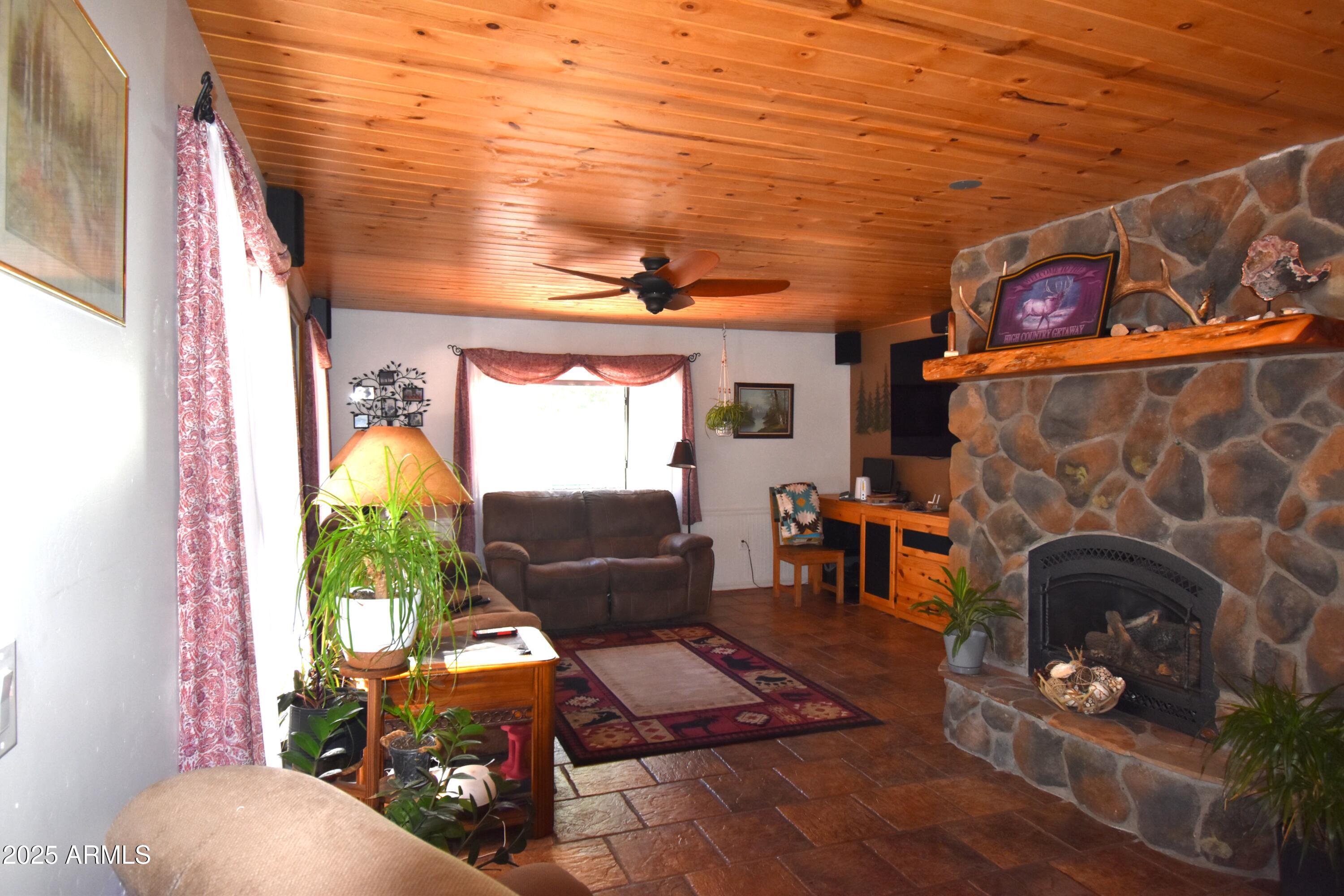 8742 Tonto Rim Drive Pine, AZ 85544 - Photo 22 of 41 a living room with furniture and a fireplace
