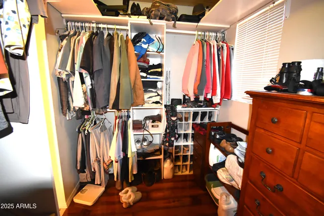 a view of a refrigerator in kitchen and an empty room