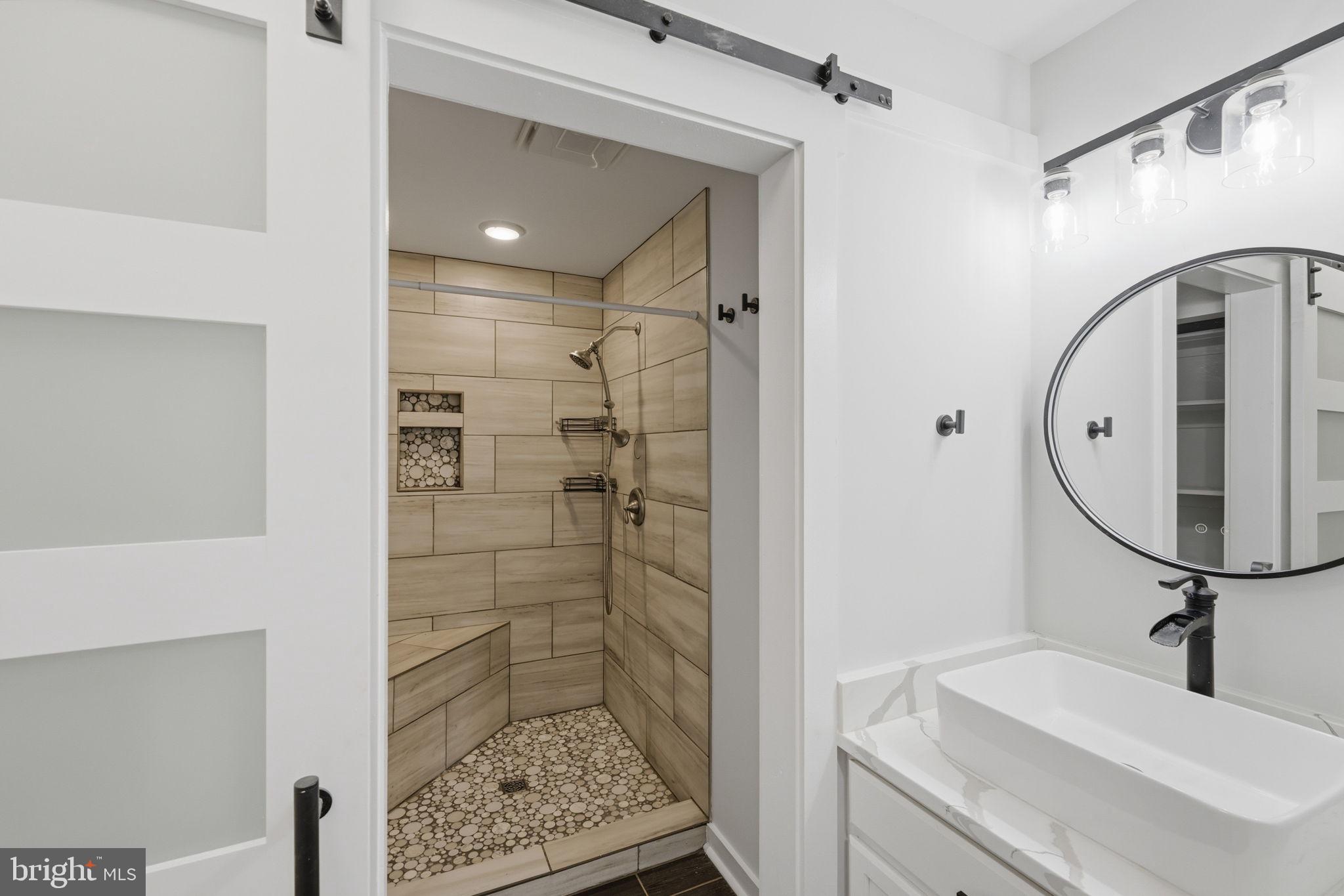 7522 Stubbs Bridge Road Spotsylvania, VA 22551 - Photo 19 of 60 a bathroom with a sink a toilet and shower