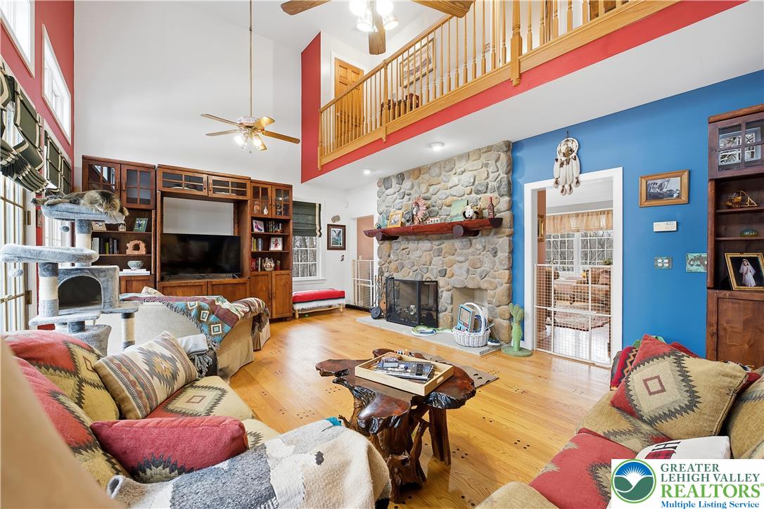 6688 Haasadahl Road Allentown, PA 18106 - Photo 11 of 34 a living room with fireplace furniture and a fireplace