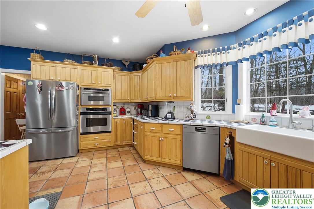 6688 Haasadahl Road Allentown, PA 18106 - Photo 16 of 34 a kitchen with stainless steel appliances a sink counter space and a window