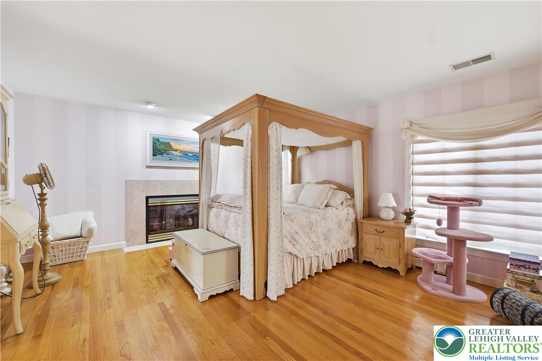 6688 Haasadahl Road Allentown, PA 18106 - Photo 18 of 33 a living room with furniture a fireplace and a table