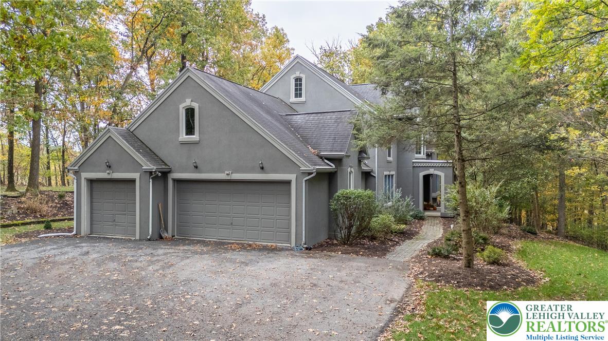 6688 Haasadahl Road Allentown, PA 18106 - Photo 2 of 34 a front view of house with yard and trees in the background