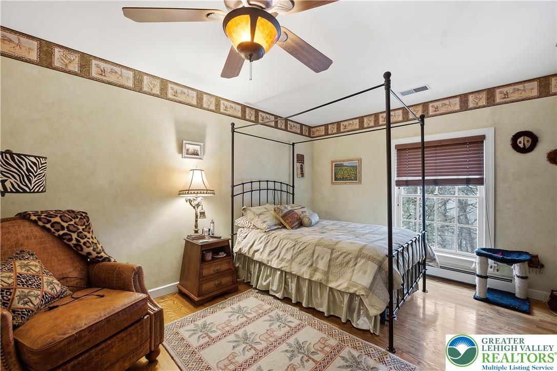 6688 Haasadahl Road Allentown, PA 18106 - Photo 23 of 33 a bedroom with a bed couch and a window