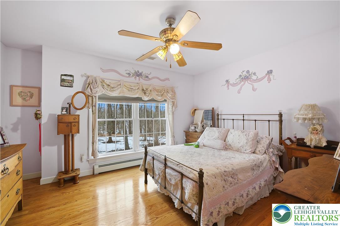 6688 Haasadahl Road Allentown, PA 18106 - Photo 23 of 34 a bedroom with a bed and a chandelier