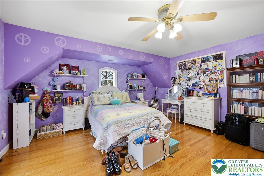 6688 Haasadahl Road Allentown, PA 18106 - Photo 24 of 33 a bedroom with bed and a chandelier