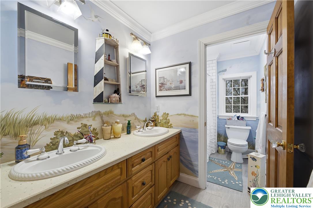 6688 Haasadahl Road Allentown, PA 18106 - Photo 25 of 33 a bathroom with a sink double vanity and a toilet