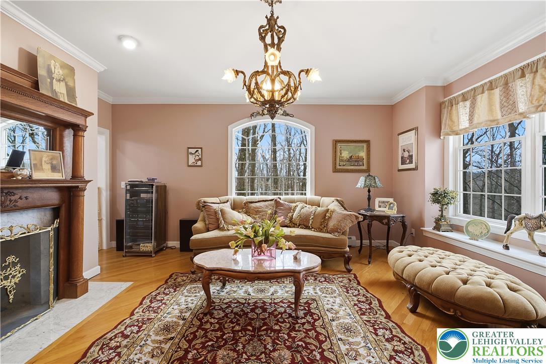 6688 Haasadahl Road Allentown, PA 18106 - Photo 6 of 34 a living room with furniture a fireplace and a chandelier