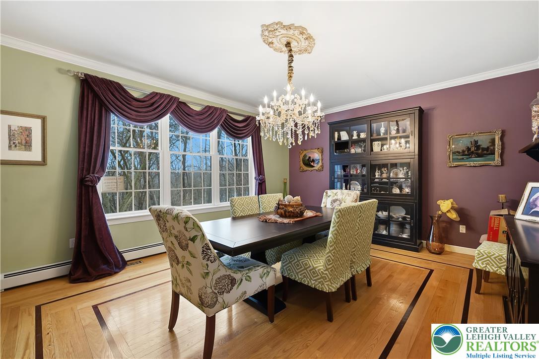 6688 Haasadahl Road Allentown, PA 18106 - Photo 7 of 33 a view of a dining room with furniture a chandelier and wooden floor