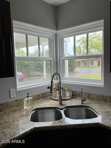 a sink with granite countertop a sink and a window