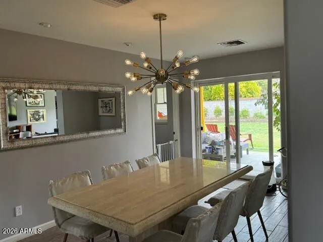 a dining room with furniture a chandelier and window