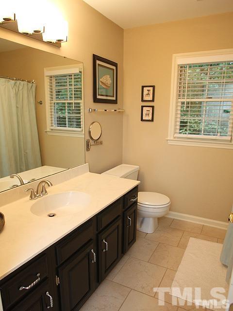 5944 Dunbarton Way Raleigh, NC 27613 - Photo 11 of 19 a bathroom with a sink mirror vanity and toilet