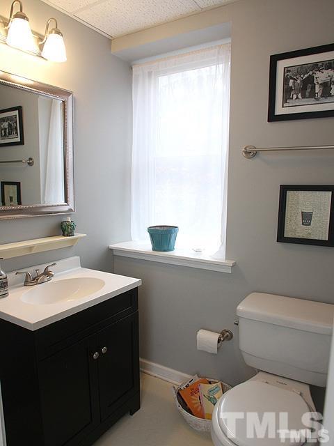 5944 Dunbarton Way Raleigh, NC 27613 - Photo 12 of 19 a bathroom with a toilet sink and mirror