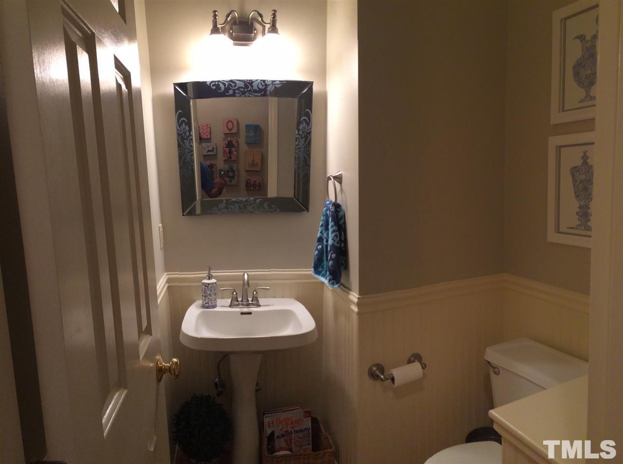 5944 Dunbarton Way Raleigh, NC 27613 - Photo 13 of 19 a bathroom with a sink mirror vanity and toilet