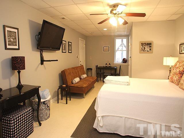 5944 Dunbarton Way Raleigh, NC 27613 - Photo 14 of 19 a spacious bedroom with a bed and a flat screen tv