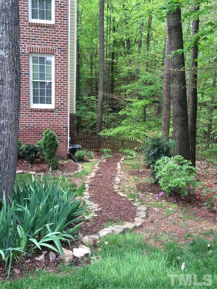 5944 Dunbarton Way Raleigh, NC 27613 - Photo 15 of 19 a view of a backyard with plants and large trees
