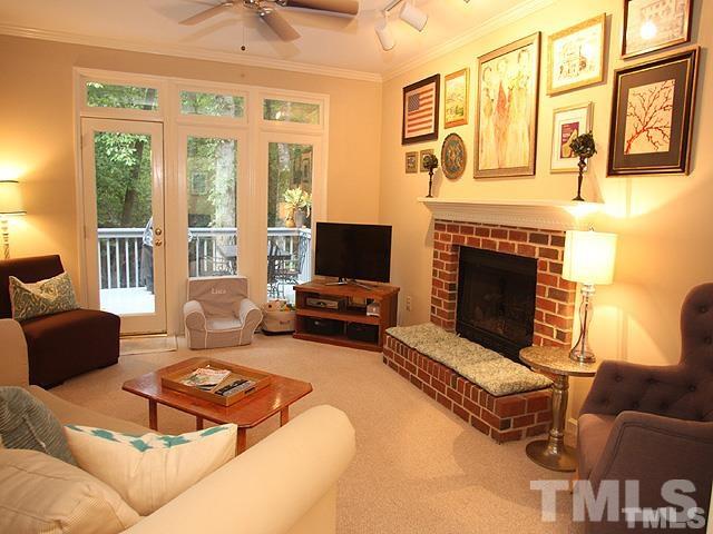 5944 Dunbarton Way Raleigh, NC 27613 - Photo 4 of 19 a living room with furniture large window and a fireplace