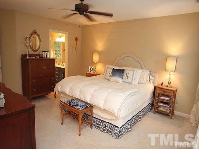 5944 Dunbarton Way Raleigh, NC 27613 - Photo 5 of 19 a bedroom with a bed and a chandelier