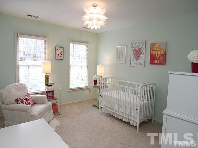 5944 Dunbarton Way Raleigh, NC 27613 - Photo 9 of 19 a bedroom with a baby bed baby crib and a window