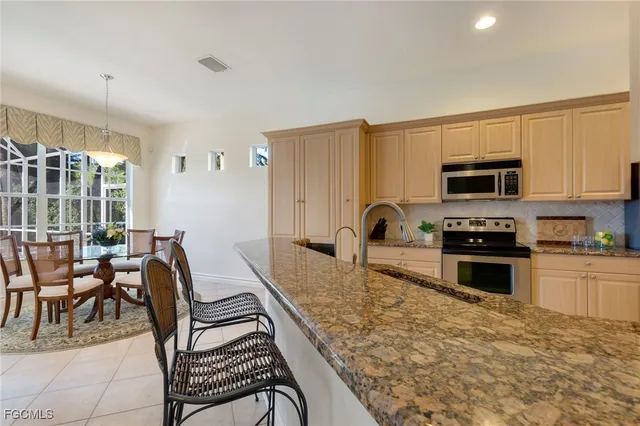 a kitchen with a stove a sink and a microwave