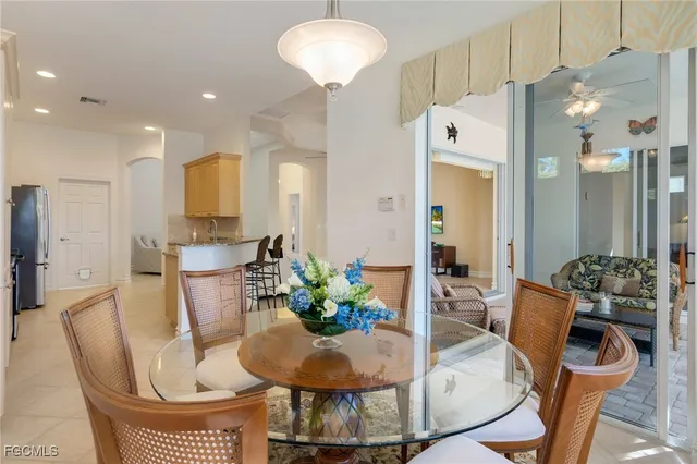 a dining room with furniture and a chandelier
