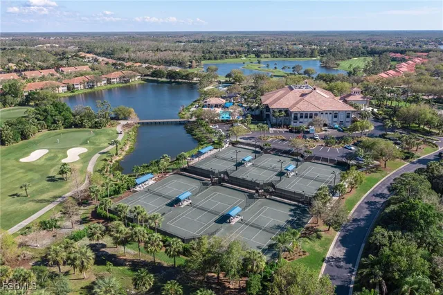 an aerial view of lake and residential houses with outdoor space
