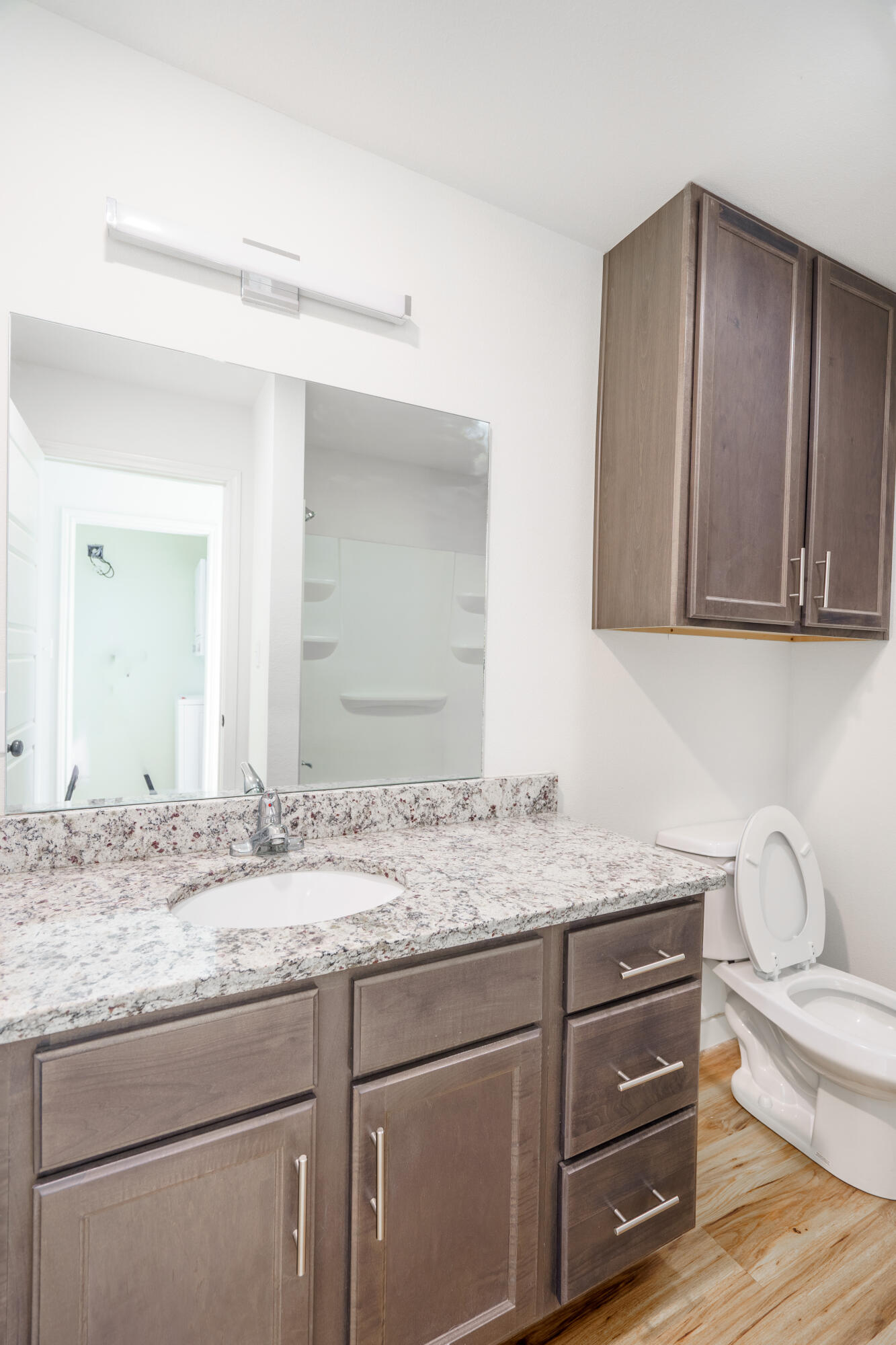 2007 Main Street, Unit 3 Lubbock, TX 79401 - Photo 11 of 23 a bathroom with a granite countertop sink and a mirror