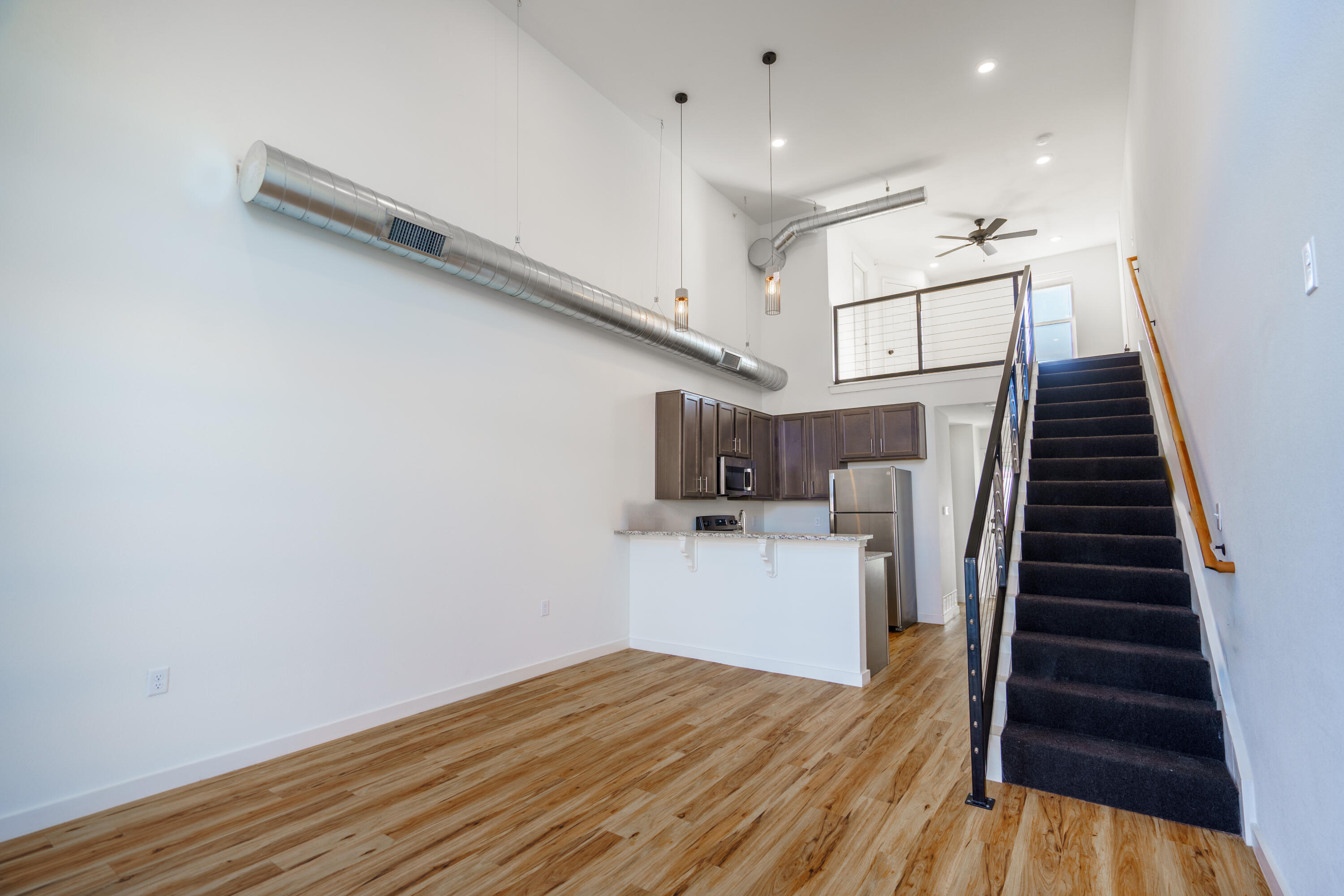 2007 Main Street, Unit 3 Lubbock, TX 79401 - Photo 3 of 23 a view of entryway and kitchen with wooden floor