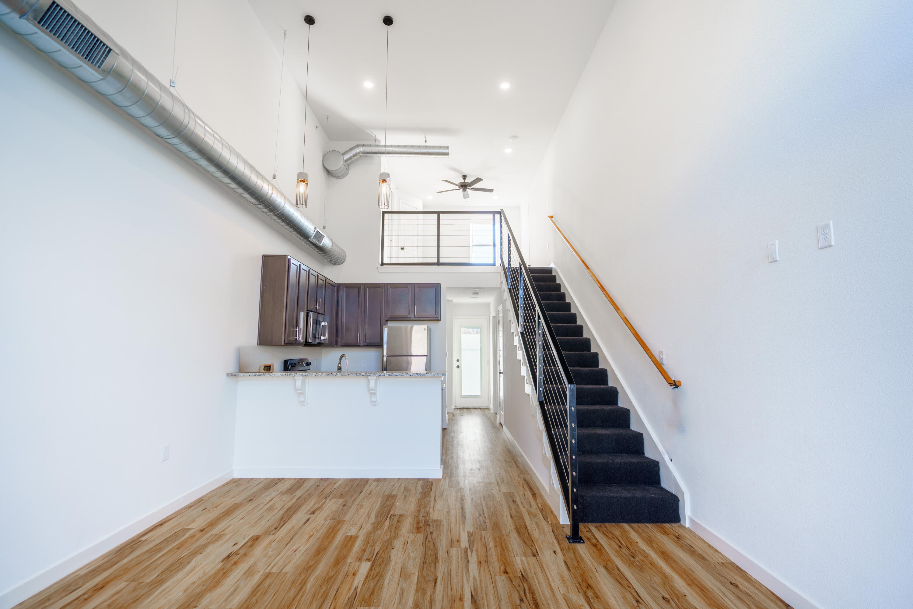 2007 Main Street, Unit 3 Lubbock, TX 79401 - Photo 4 of 23 a view of entryway and kitchen with wooden floor