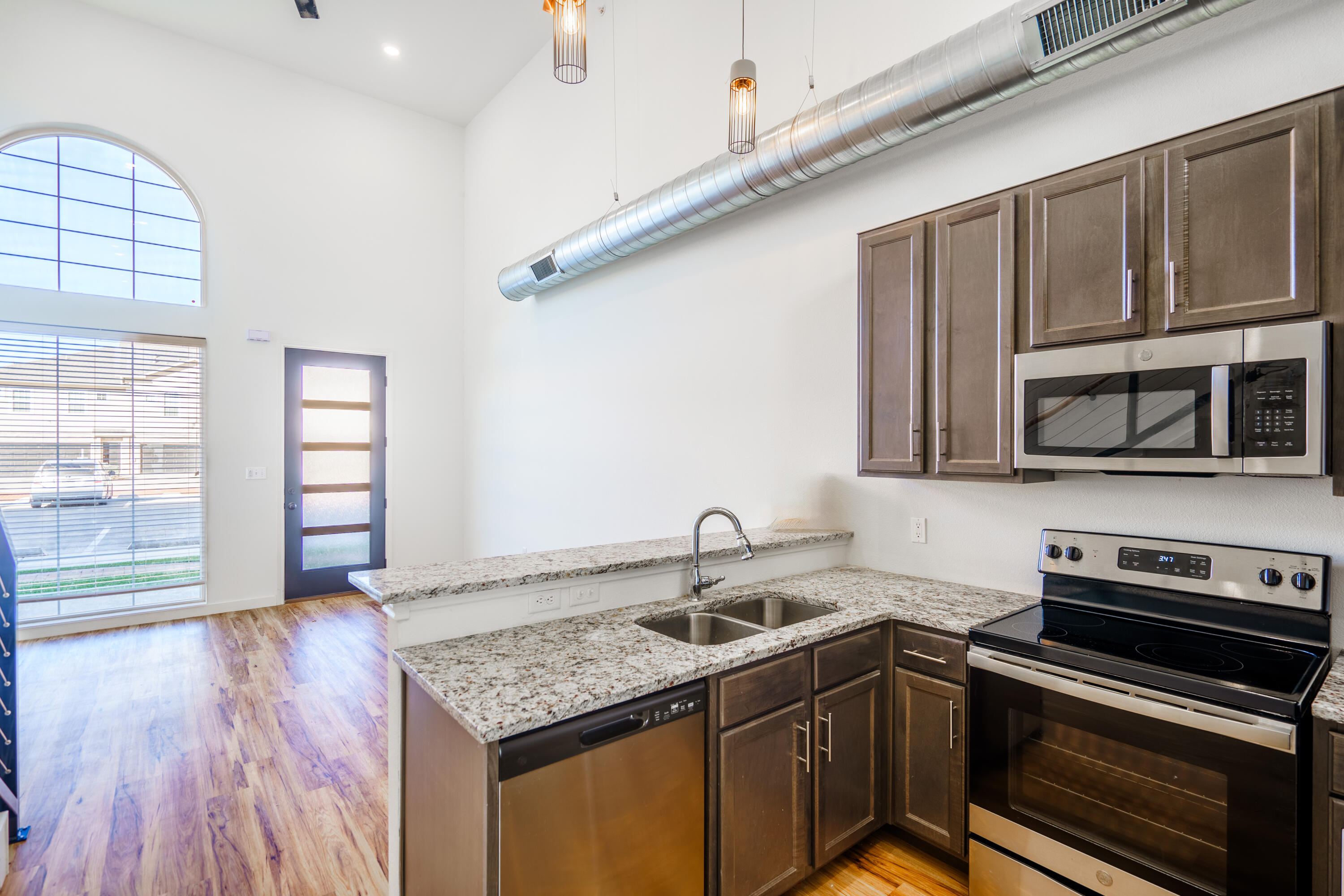 2007 Main Street, Unit 3 Lubbock, TX 79401 - Photo 5 of 23 a kitchen with stainless steel appliances granite countertop a sink and a microwave
