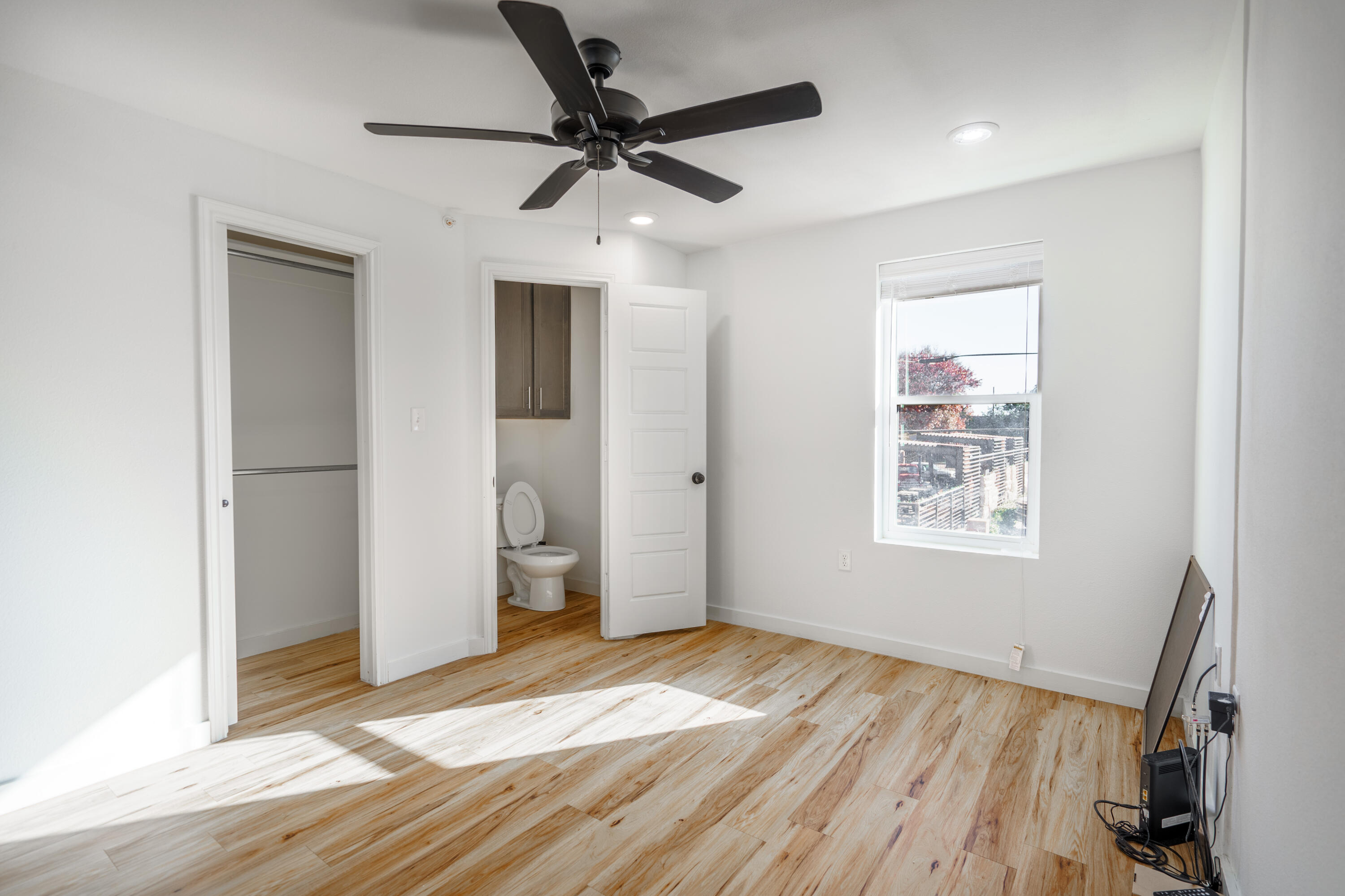 2007 Main Street, Unit 3 Lubbock, TX 79401 - Photo 10 of 23 a view of empty room with wooden floor and fan