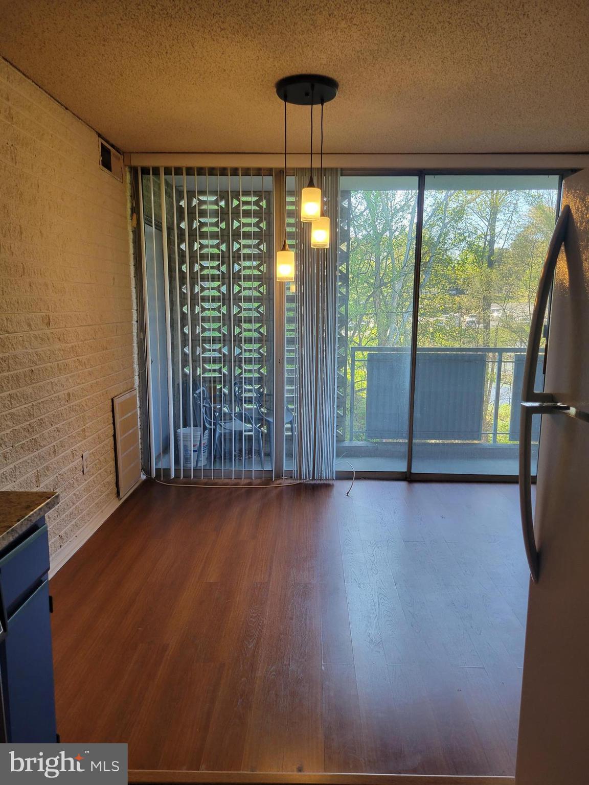 1830 Metzerott Road, Unit 103 Hyattsville, MD 20783 - Photo 12 of 41 a view of empty room with wooden floor and fan