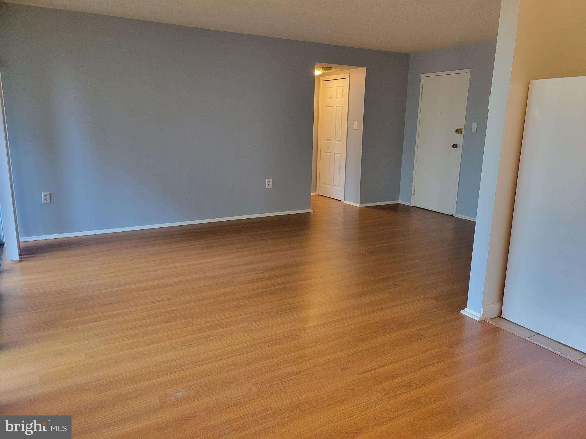 1830 Metzerott Road, Unit 103 Hyattsville, MD 20783 - Photo 14 of 41 a view of an empty room with wooden floor and a window