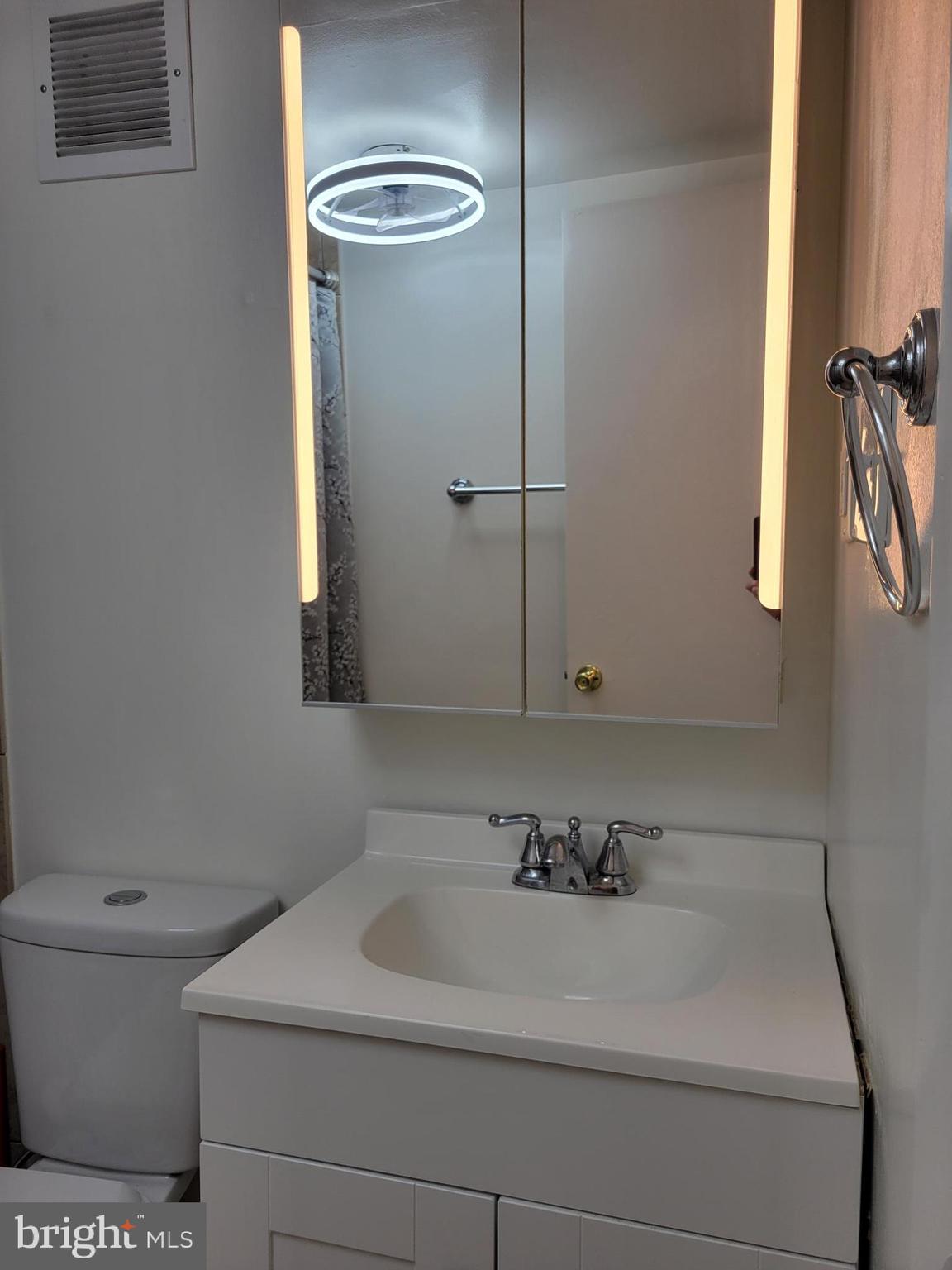 1830 Metzerott Road, Unit 103 Hyattsville, MD 20783 - Photo 23 of 41 a bathroom with a sink a toilet and a mirror