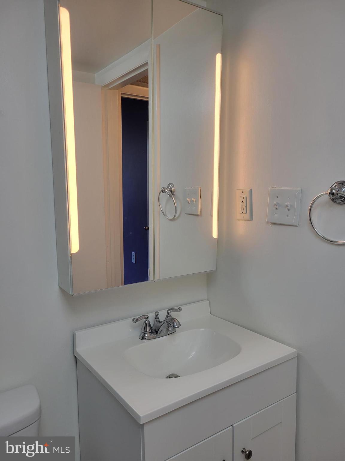 1830 Metzerott Road, Unit 103 Hyattsville, MD 20783 - Photo 24 of 41 a bathroom with a sink and a mirror