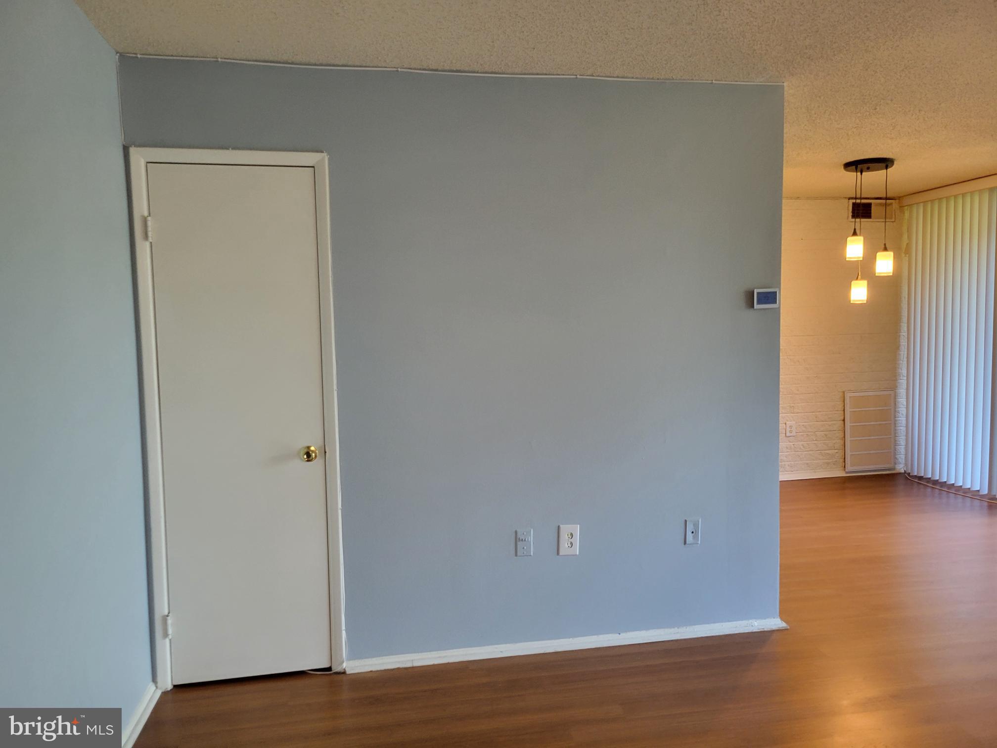 1830 Metzerott Road, Unit 103 Hyattsville, MD 20783 - Photo 3 of 41 a view of an empty room with wooden floor and a closet