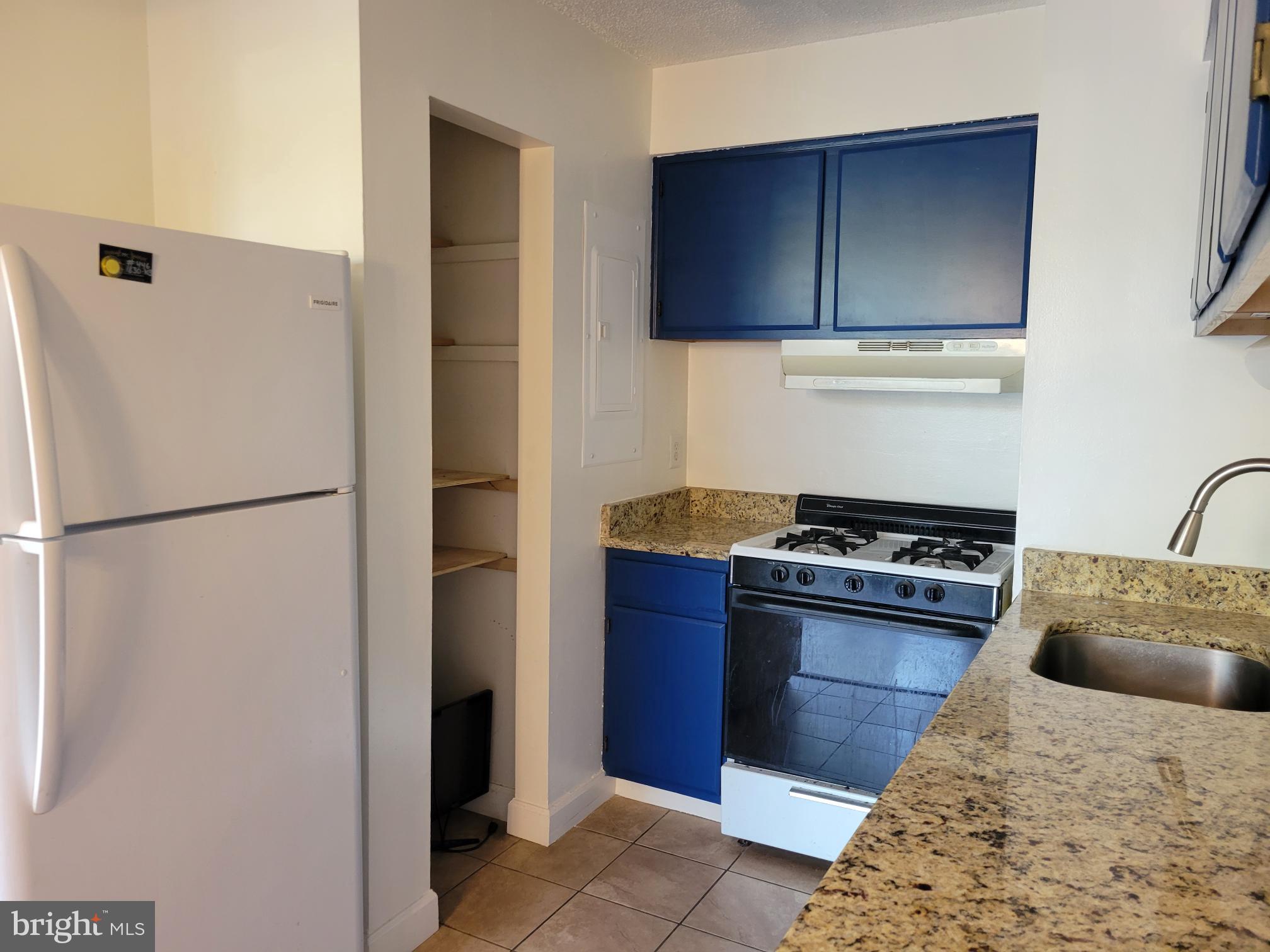 1830 Metzerott Road, Unit 103 Hyattsville, MD 20783 - Photo 8 of 41 a kitchen with stainless steel appliances granite countertop a refrigerator stove and sink
